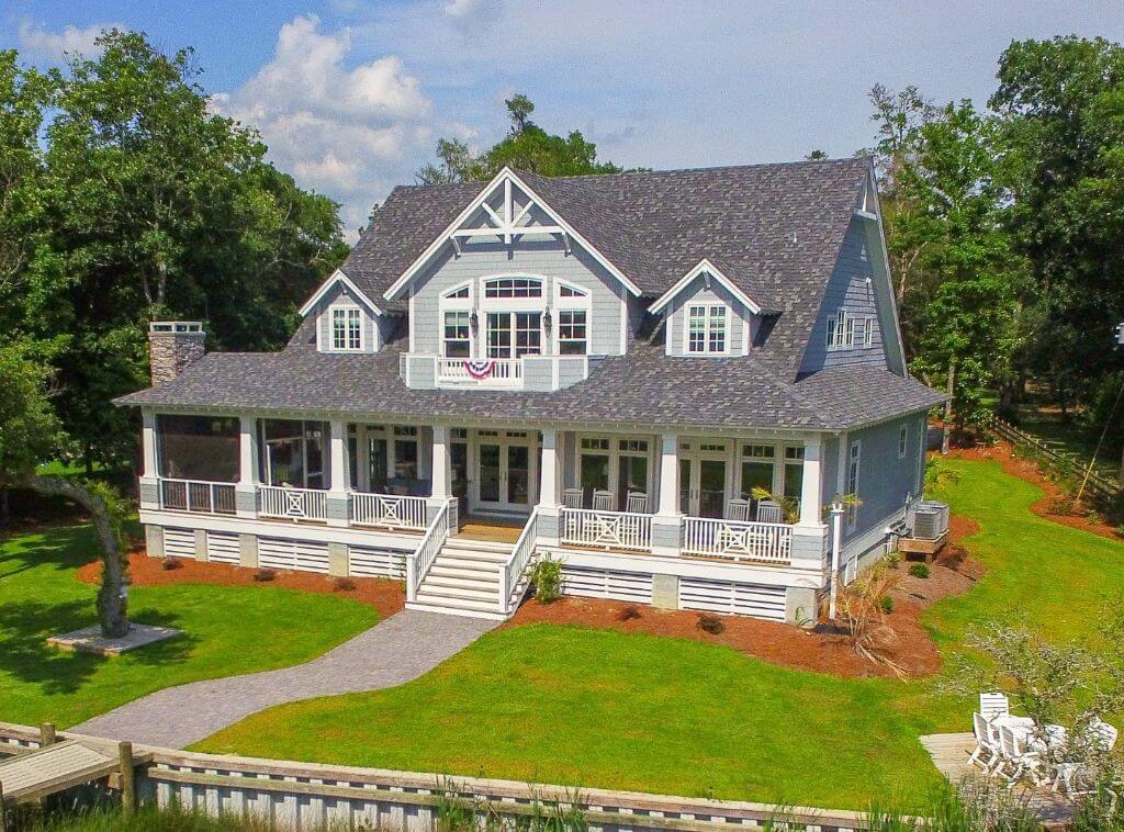 Front ariel view of house, with peak roof and large sundeck.