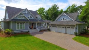 Photo of light blue home with separate 3 car garage.